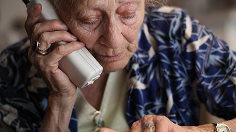 anziana al telefono con giornale